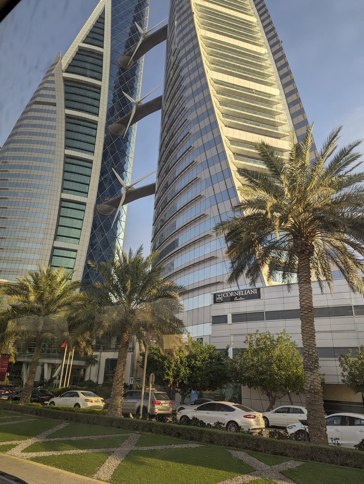 The twin sail-shaped towers of the Bahrain World Trade Center with wind turbines mounted between them