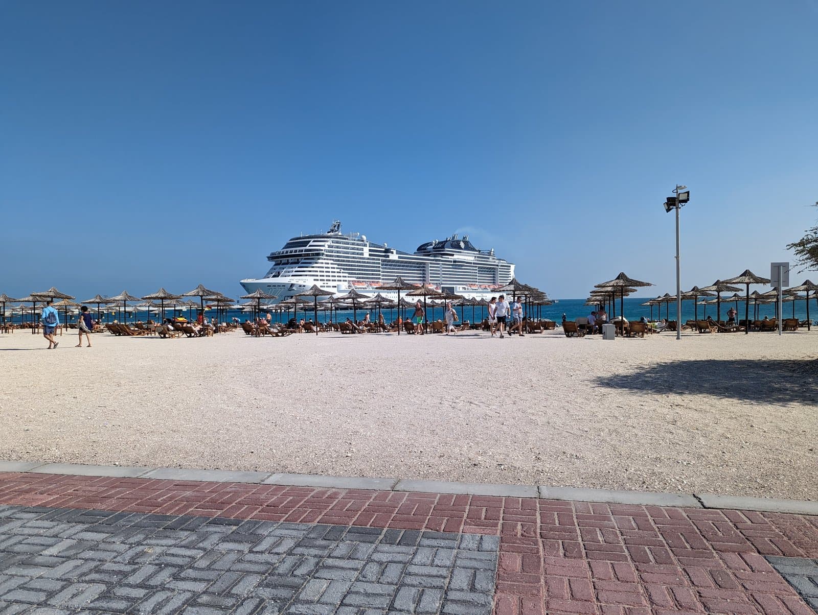 Cruise ship anchored off the beach at Sir Bani Yas Island, seen from the sand