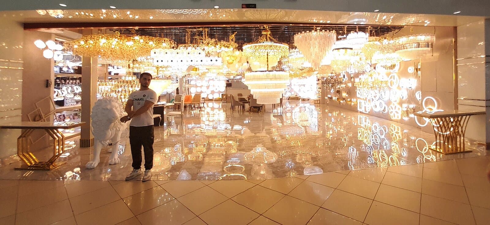 A chandelier and lighting shop inside Dragon Mart, with dozens of ornate fixtures hanging from the ceiling