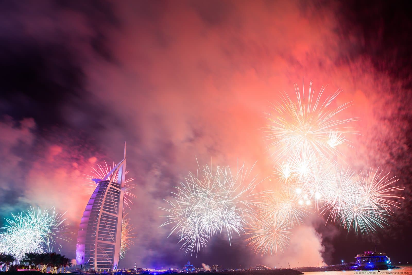 Burj Al Arab illuminated at night, seen from the Dubai coastline