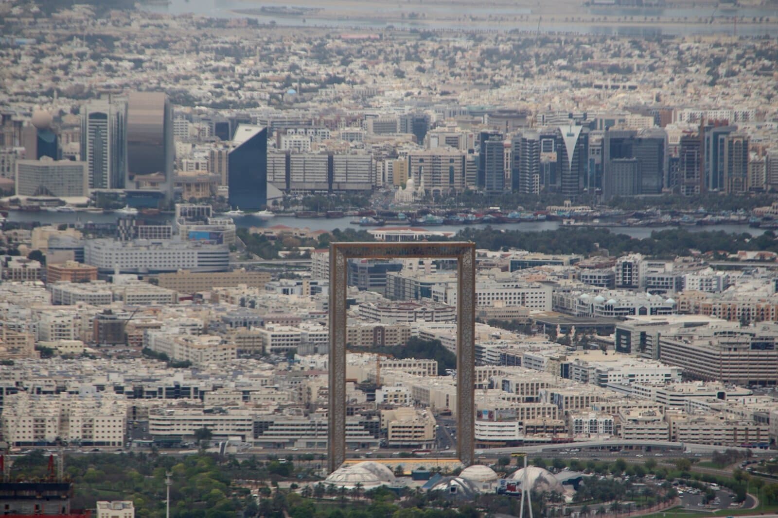 Dubai Frame seen from a distance, framing the older, low-rise part of Dubai against the modern skyline behind it