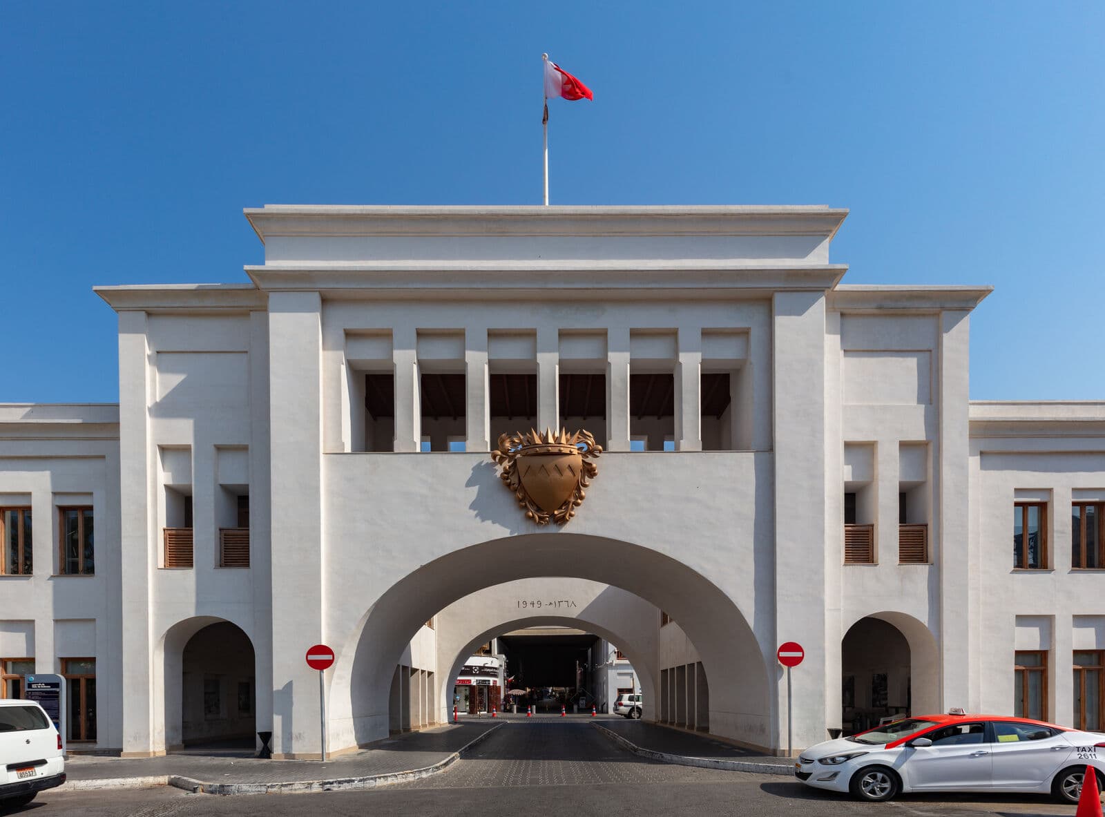 Bab Al Bahrain, the arched 1949 gateway to Manama Souq, with the Bahrain flag flying above it