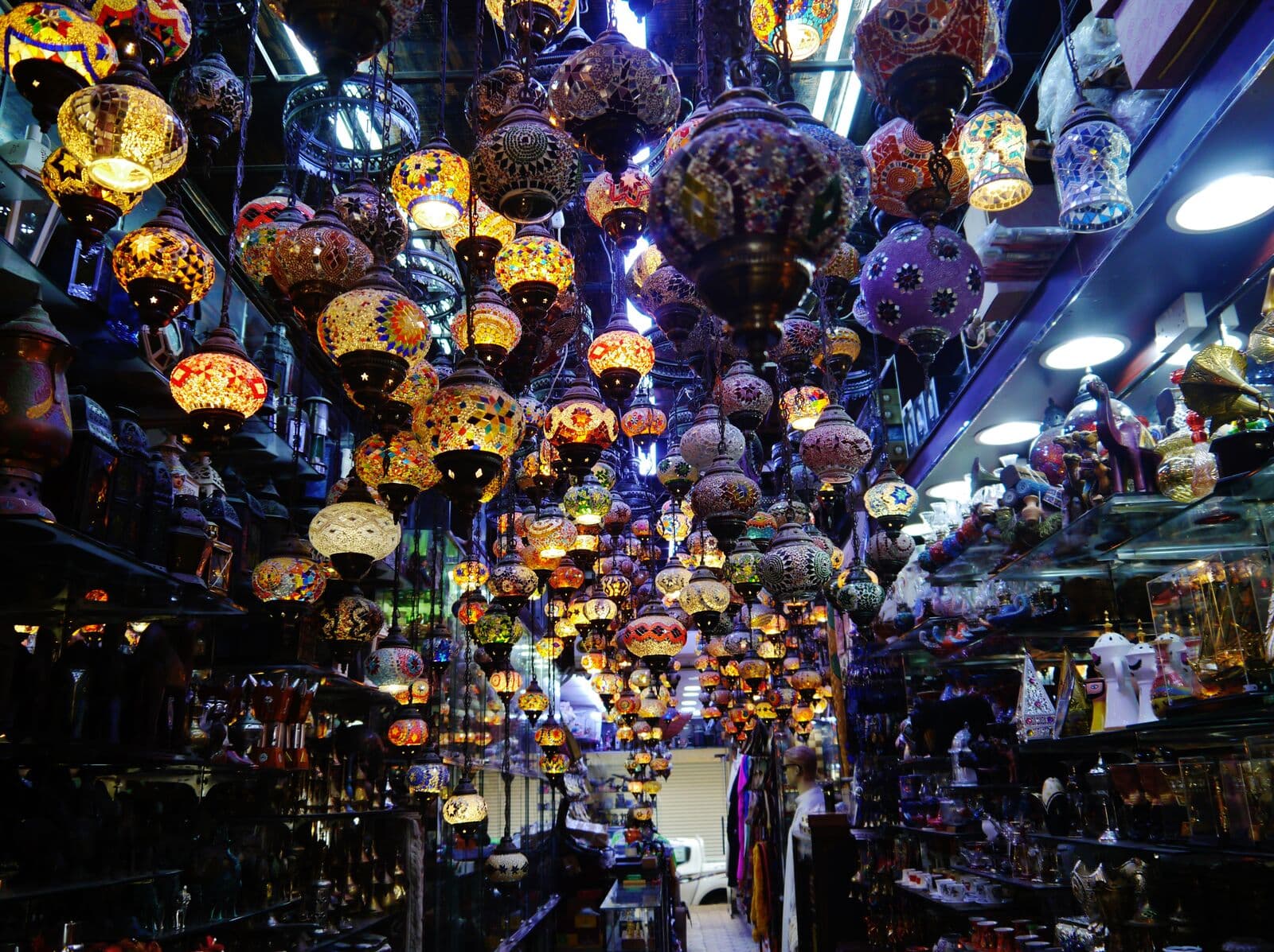 Colourful mosaic lamps hanging from the ceiling of a shop inside Manama Souq